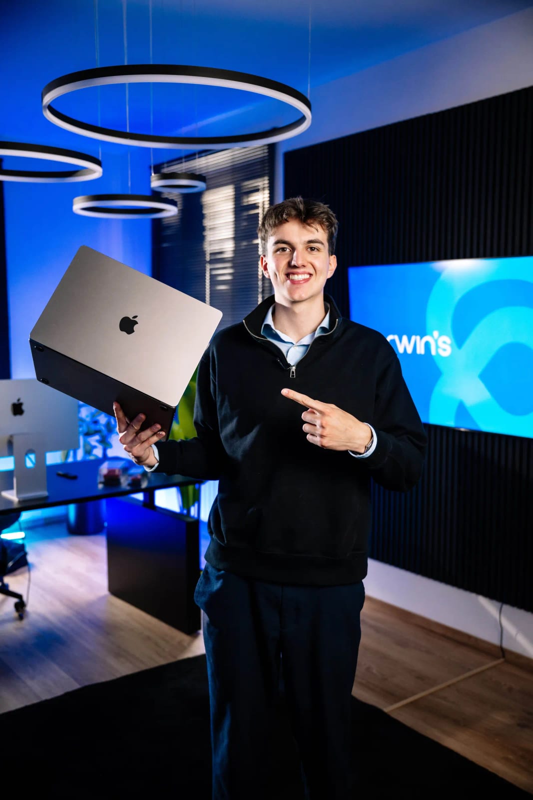 Leon Dapoz tiene in mano un MacBook nell’ufficio di darwin's a Bressanone e lo indica